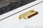 Zdjęcie przedstawia uchwyt meblowy podłużny z podstawą z serii  Royal Deluxe na meblu od Beslag Design